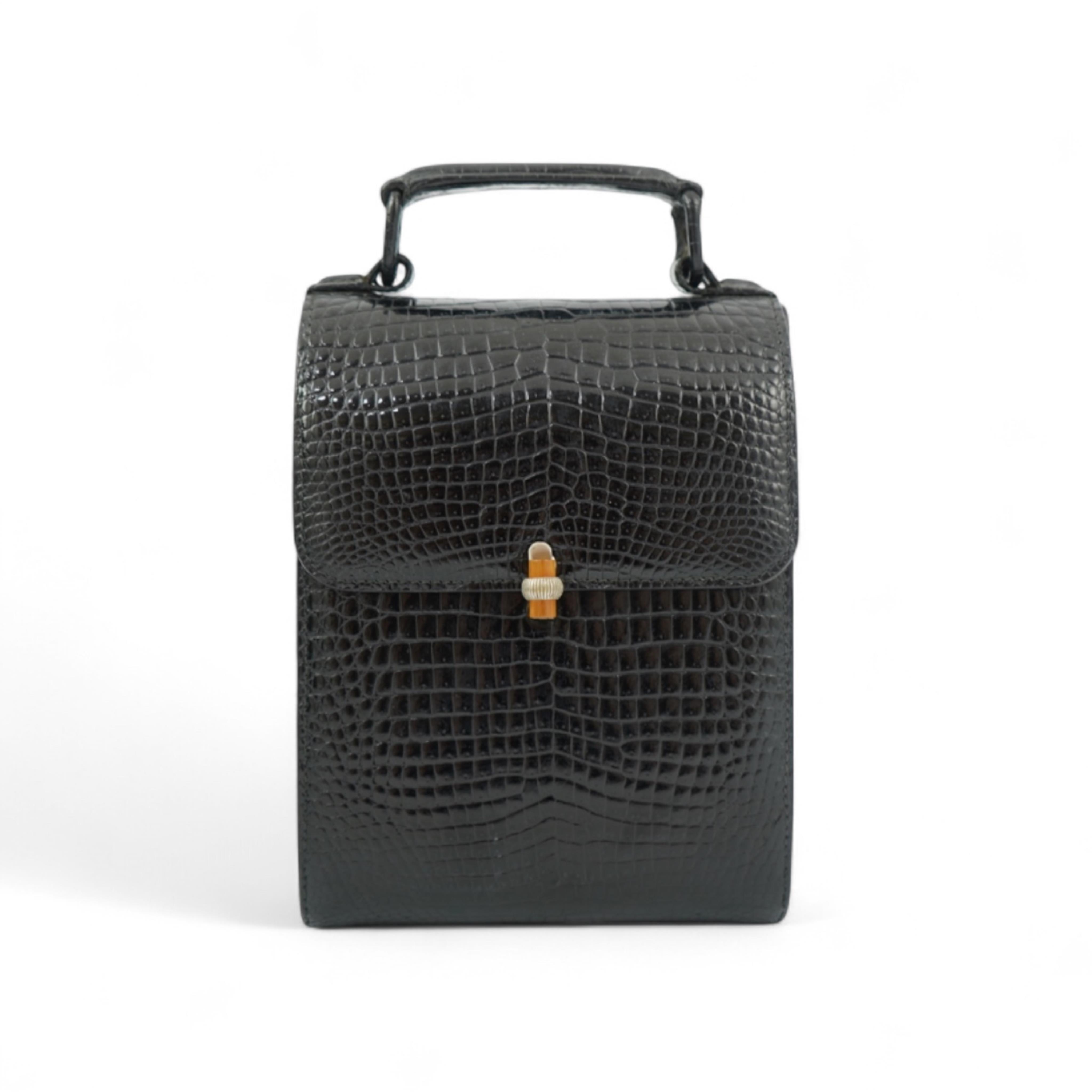 A stylish 1930’s lady’s Asprey of London, black lizard skin evening bag with ornamental amber coloured Bakelite clasp. 23cm high from handle to base. Condition- some internal scratches to lining as expected for age and u